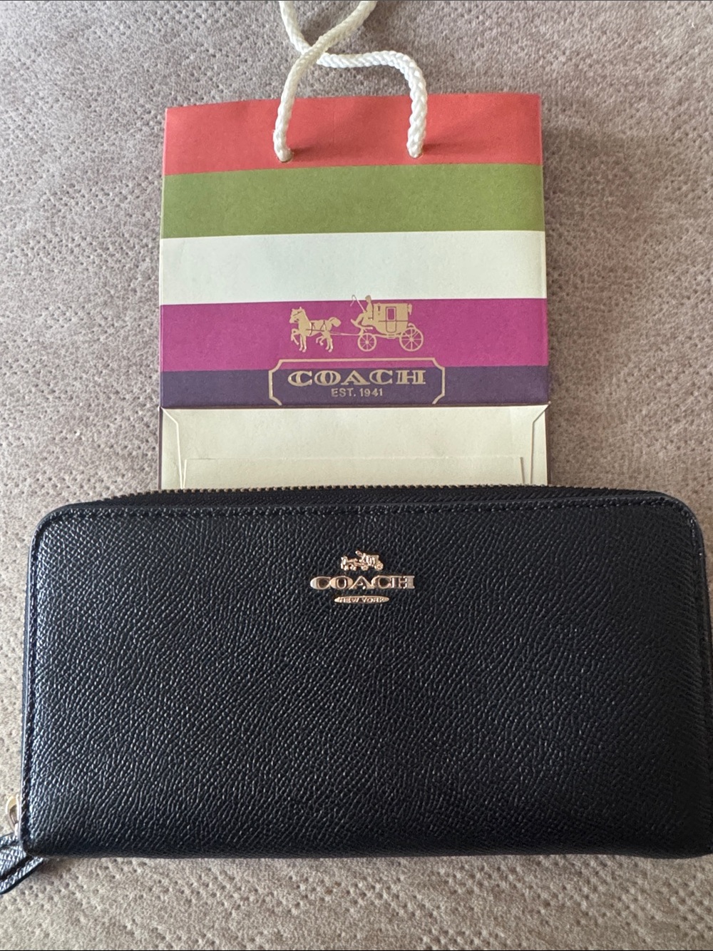 Coach Black Saffiano Zip Wallet with Gold Logo and Coach bag.